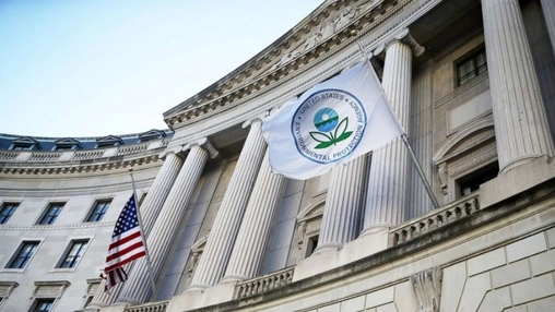 EPA flag and American flag displayed outside a neoclassical government building with large stone columns