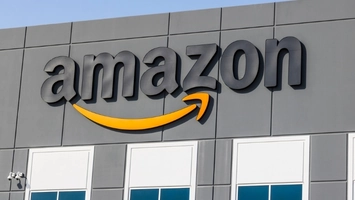 Amazon corporate building exterior with large branded logo showing the company name and orange arrow