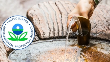 Water pouring from a metal cup at a stone basin with the United States EPA circular logo overlaid on the left