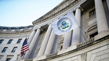 EPA flag and American flag displayed outside a neoclassical government building with large stone columns